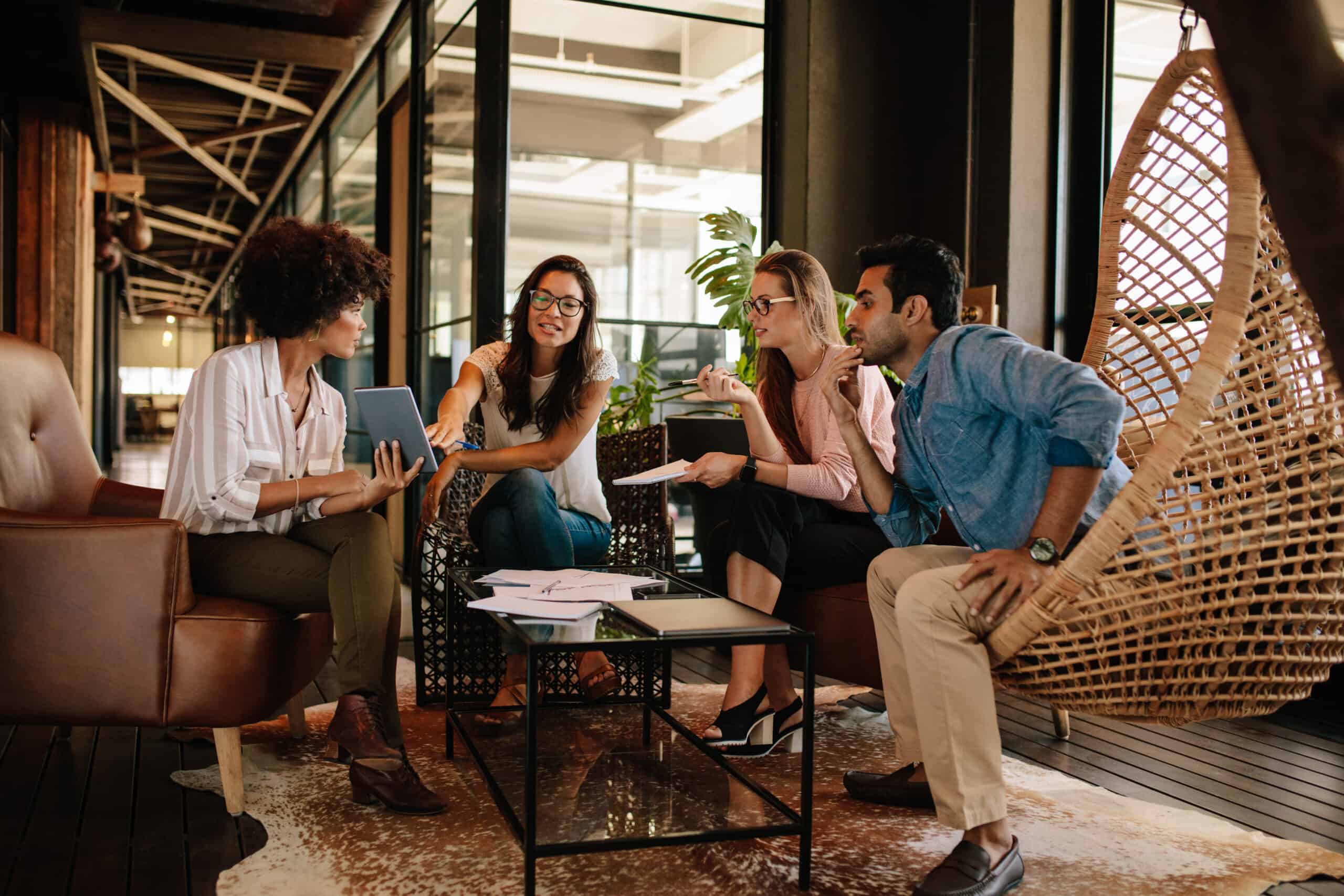 A collaborative business review around a tablet