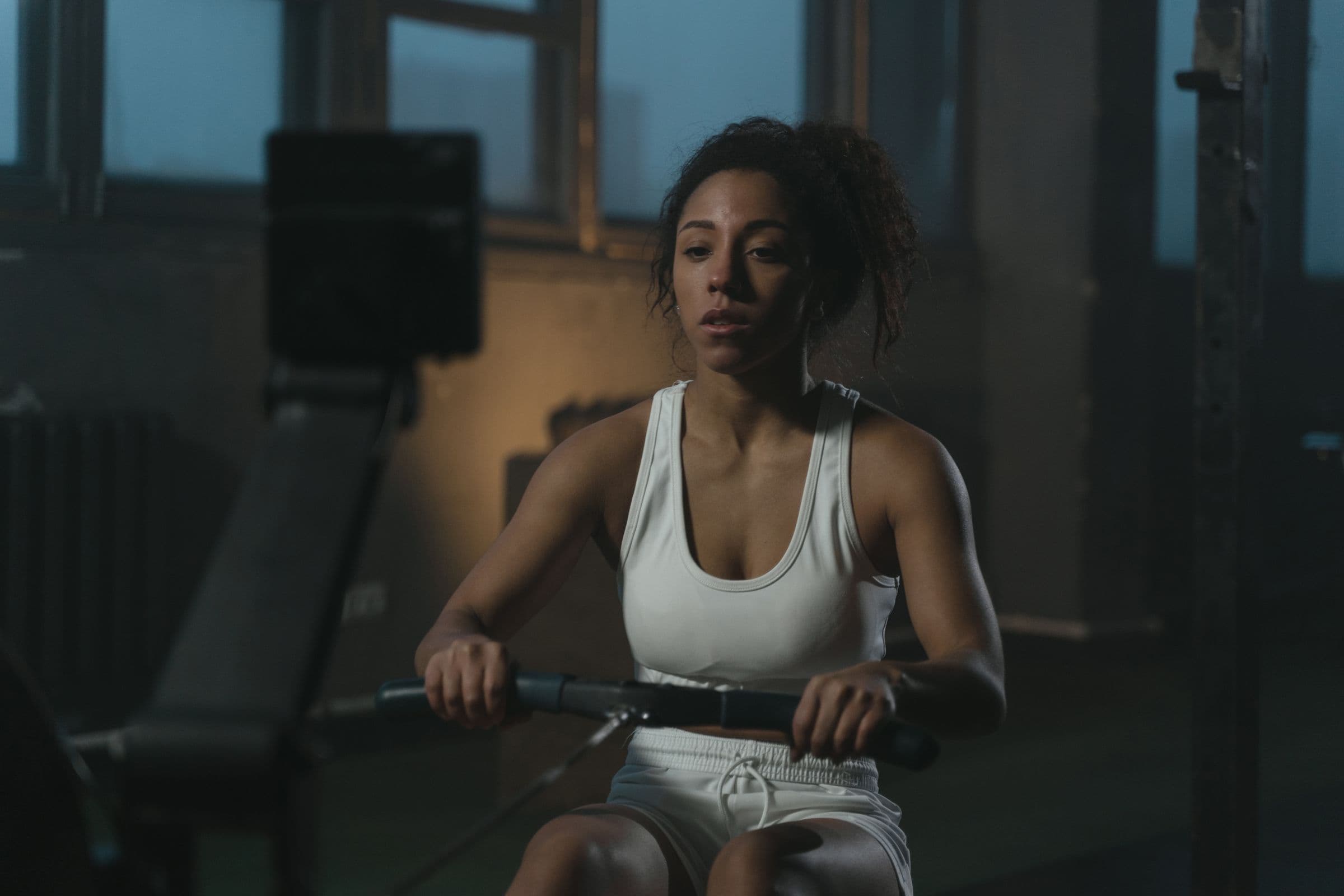 Athlete training with focus on a rowing machine