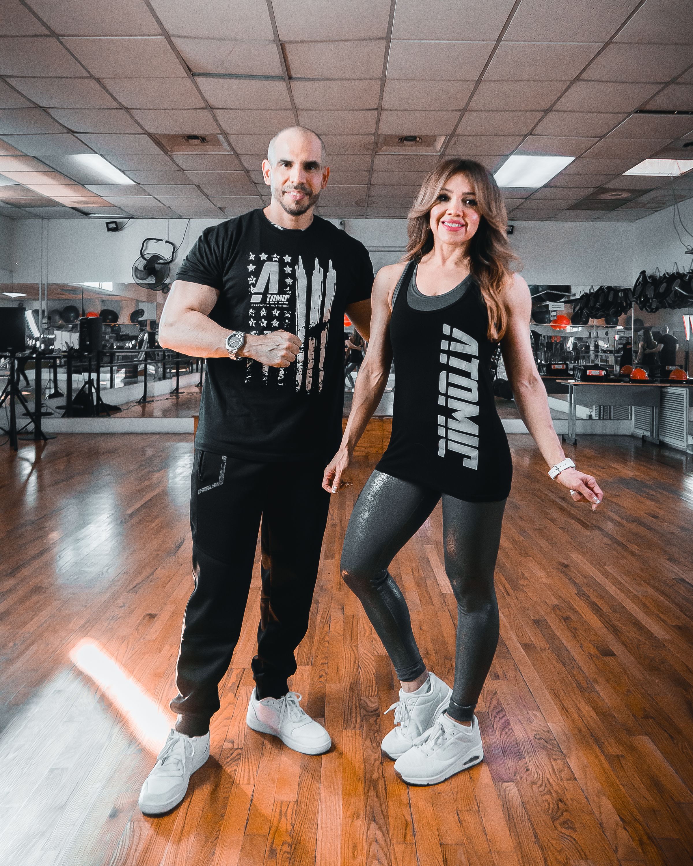 Two athletes standing inside a gym studio