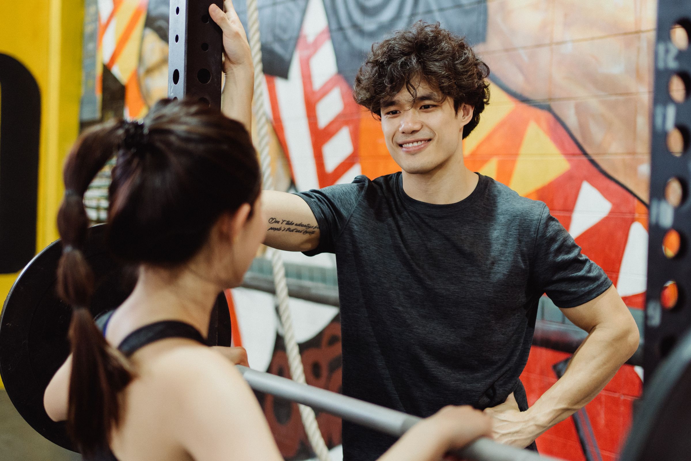 Two members training together in a climbing gym